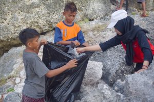 Tim ENJ UNAIR 2019 bersama warga ketika membersihkan sampah plastik di Pantai. (Foto : Istimewa)
