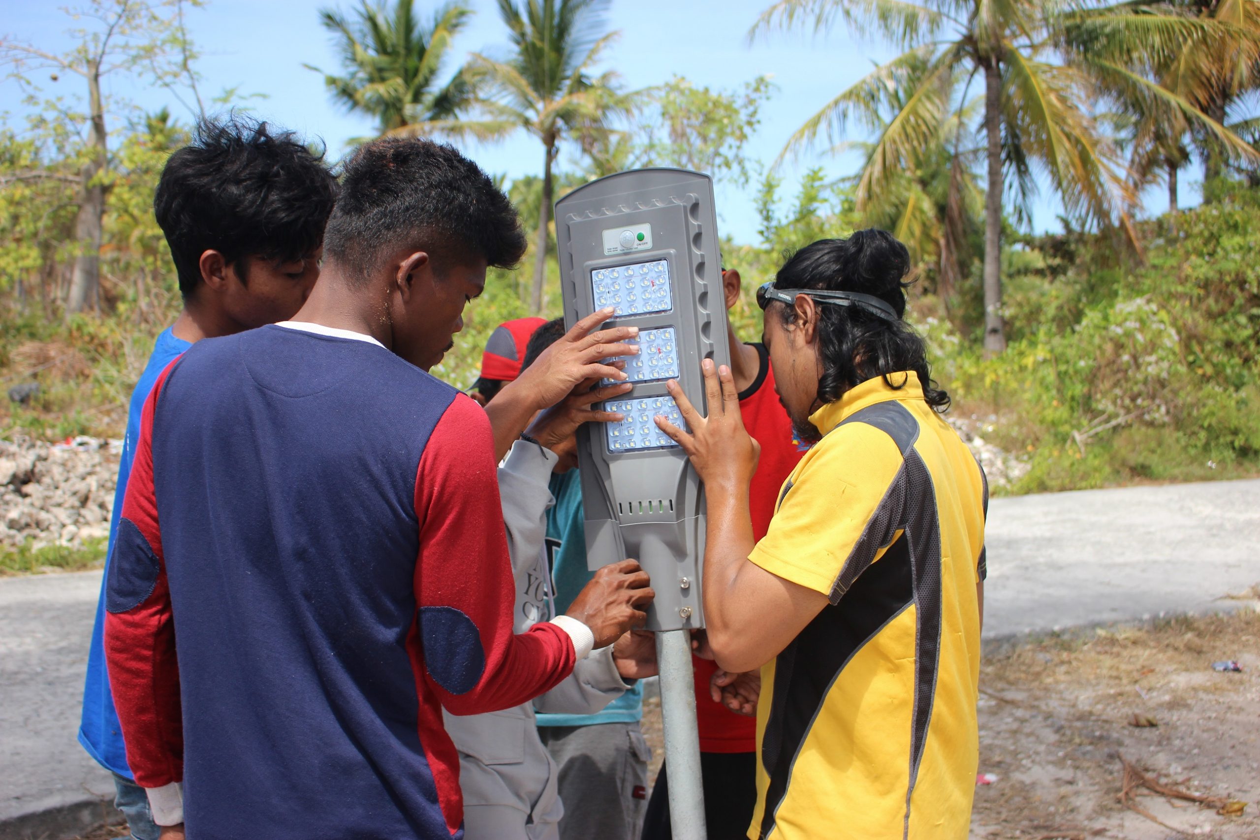 KETIKA pemasangan panel surya tim ENJ UNAIR bersama dengan pemuda desa di Dermaga Lagila. (Foto : Istimewa)