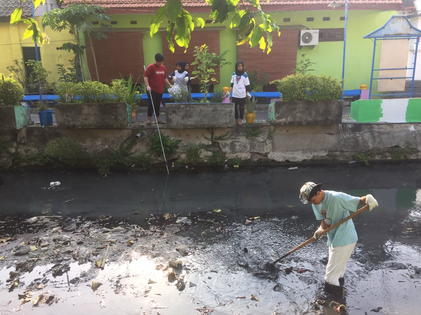 MAHASISWA FIB saat terjun langsung ke sungai Karang Menjangan untuk membersihkan sampah. (Foto: Fitri)