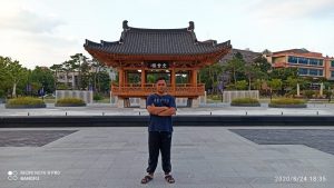 MUHAMMAD Fuad Izzatulfikri sedang berdiri di depan Jeonbuk National University. (Foto: dok. Pribadi)