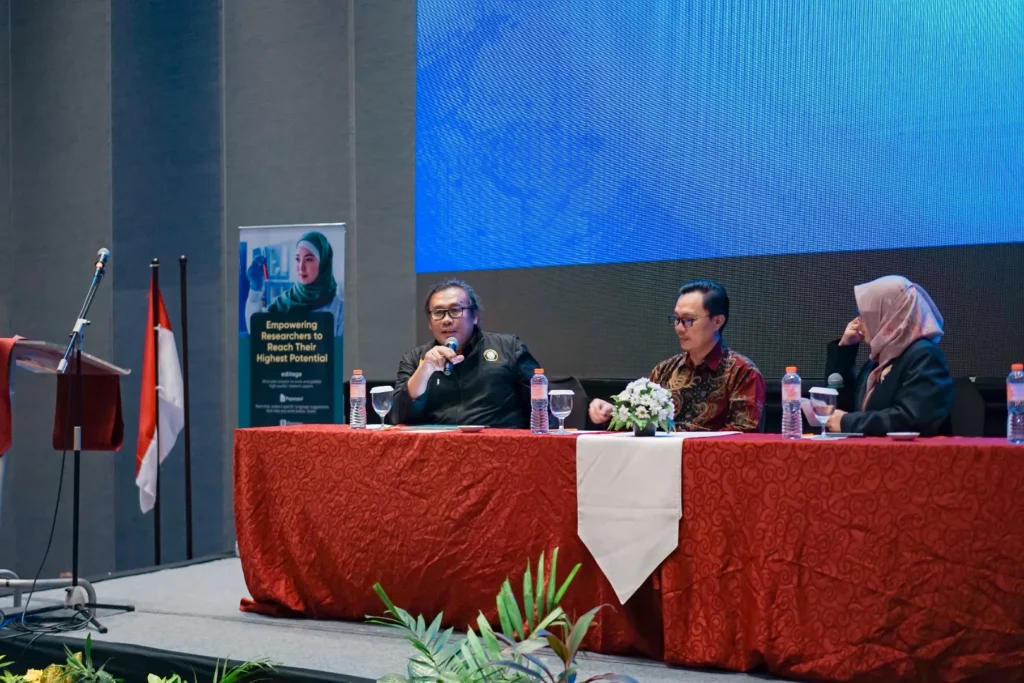 Prof. Firmansyah, S.E., M.Si., Ph.D. (LPPM UNDIP) delivers a presentation on AI in scientific publishing at Harris Hotel & Conventions Gubeng, Surabaya (July 8, 2025). (Photo: Personal Documentation)