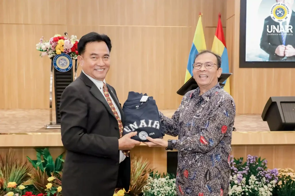 Two men are carrying a souvenir inscribed with the word “UNAIR.”