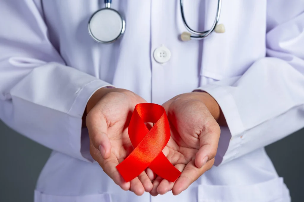 Ilustrasi Lambang Pita Merah HIV/AIDS (Sumber: Biofarma)