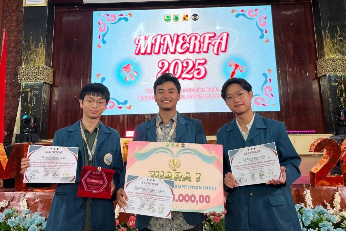 Three men wearing almamater taking picture