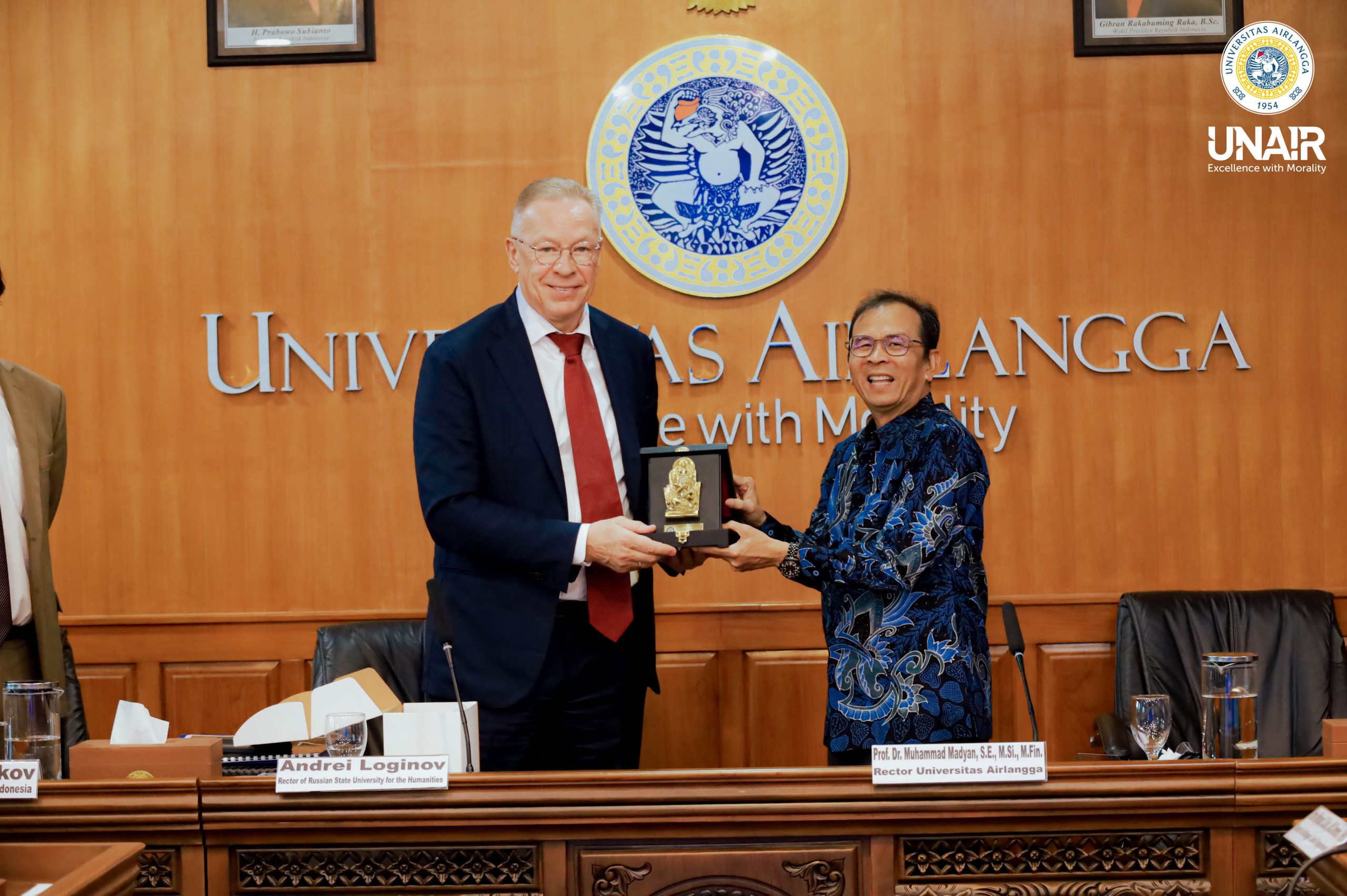 UNAIR Rector Prof. Dr. Muhammad Madyan, S.E., M.Si., M.Fin., and RSUH Rector Andrei Loginov exchange token of appreciation during the visit of Russia House and The Russian State University for the Humanities (RSUH) on Wednesday (Nov. 5, 2025). (Photo: PHMP UNAIR)