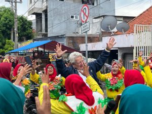 Members of the Mojo PKK community perform an opening dance wearing outfits crafted from recycled household waste. (SDGs Committee Documentation)