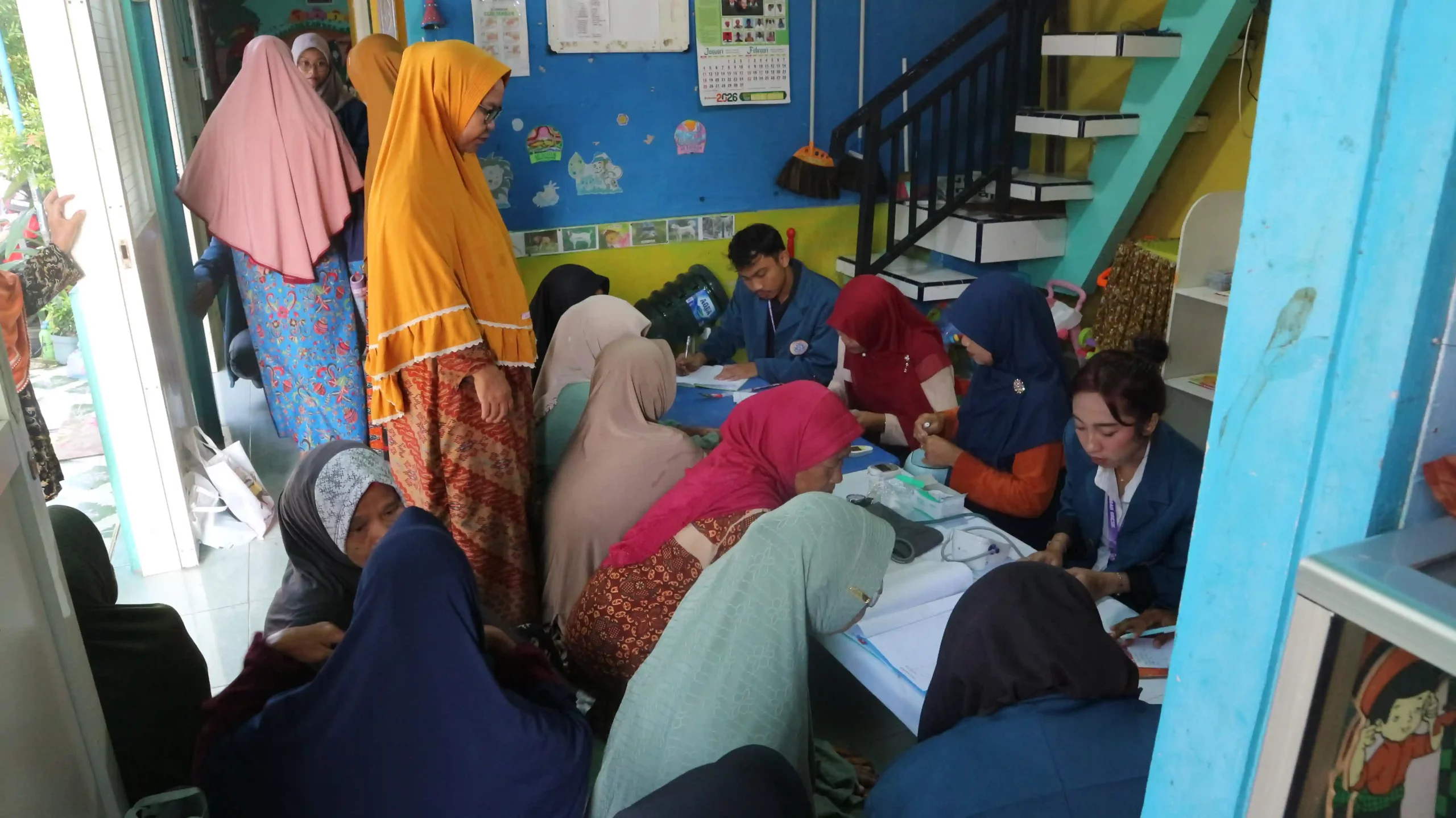 Mahasiswa BBK 7 Universitas Airlangga melaksanakan pemeriksaan kesehatan dasar kepada lansia dalam kegiatan PRIMA di Taman Posyandu Desa Kisik, Kecamatan Bungah, Kabupaten Gresik, Senin (19/1/2025). (Foto: Dok. Tim BBK 7)